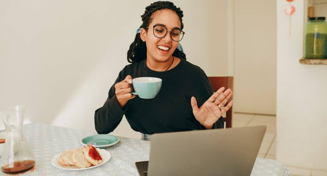 woman in black long sleeve shirt holding white ceramic mug